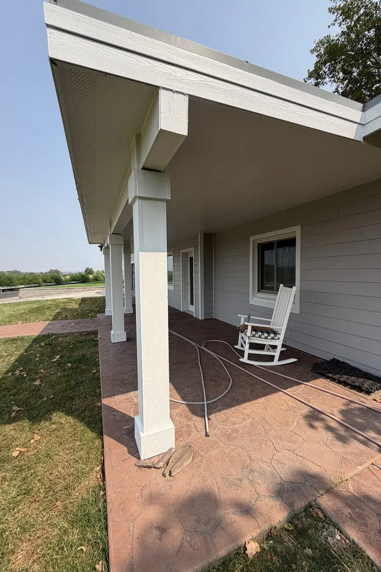 Covered porch and new siding on a completed exterior