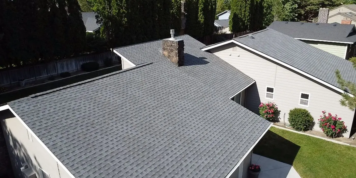 Completed roof replacement with the house and yard
