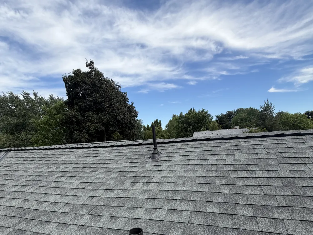 A vent penetration on new shingle, photographed during a roof inspection