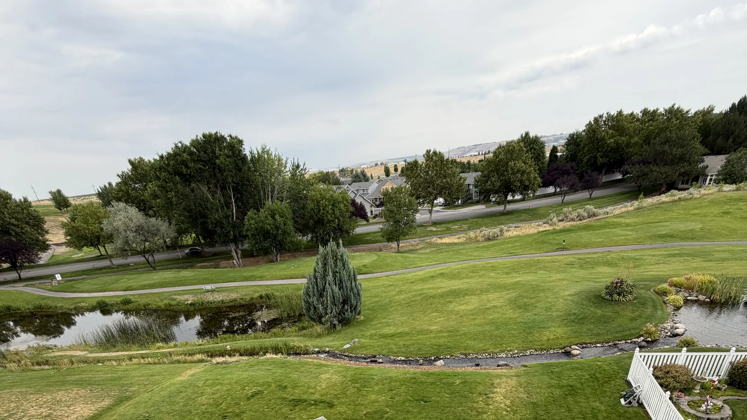 A finished shingle roof overlooking open green space and a pond in Eastern Washington