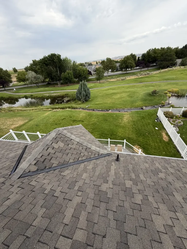 A finished roof overlooking open green space and a pond
