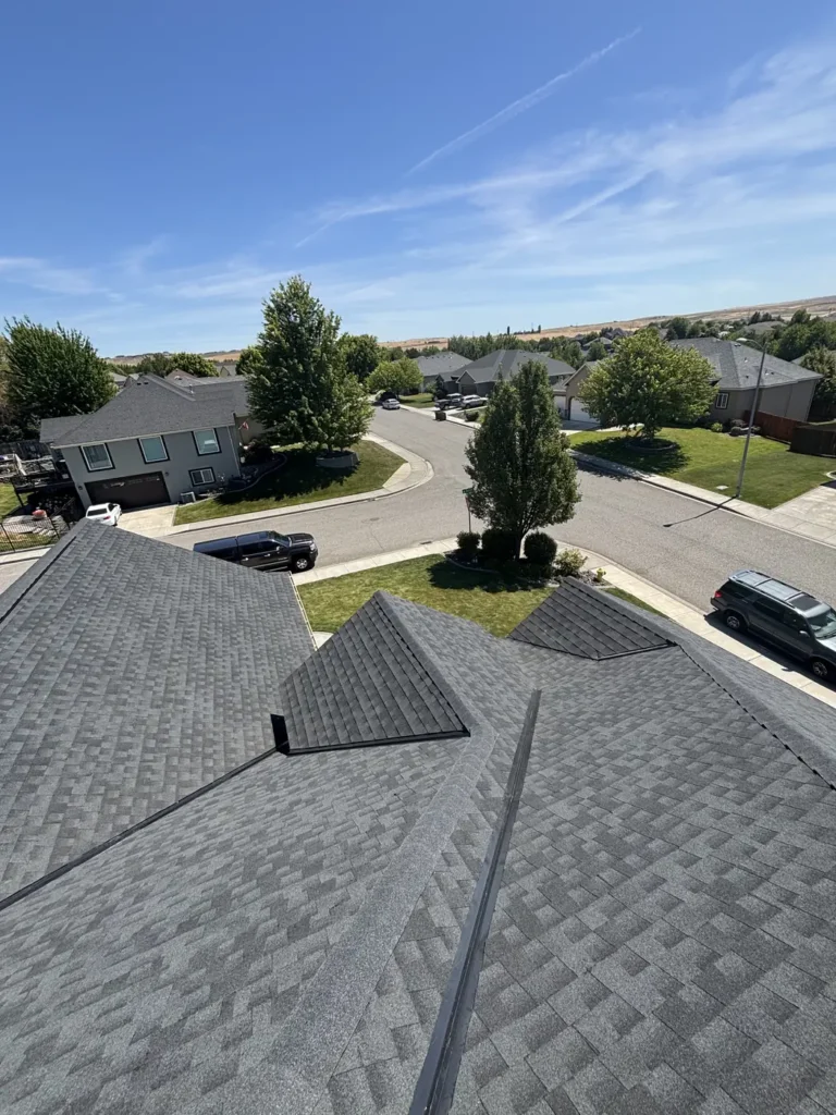 Grey shingle roof with the street and the hills beyond
