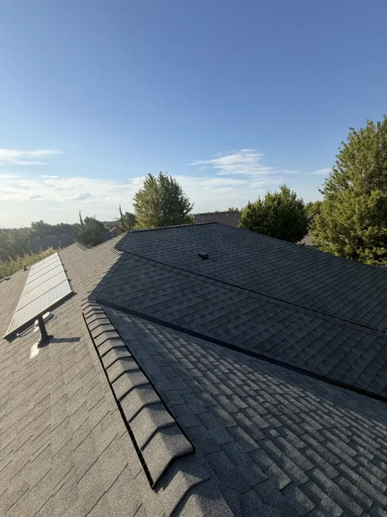 Grey architectural shingle with a rooftop solar array