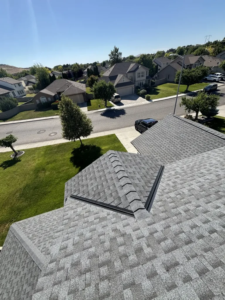New shingle roof above a front lawn and the street