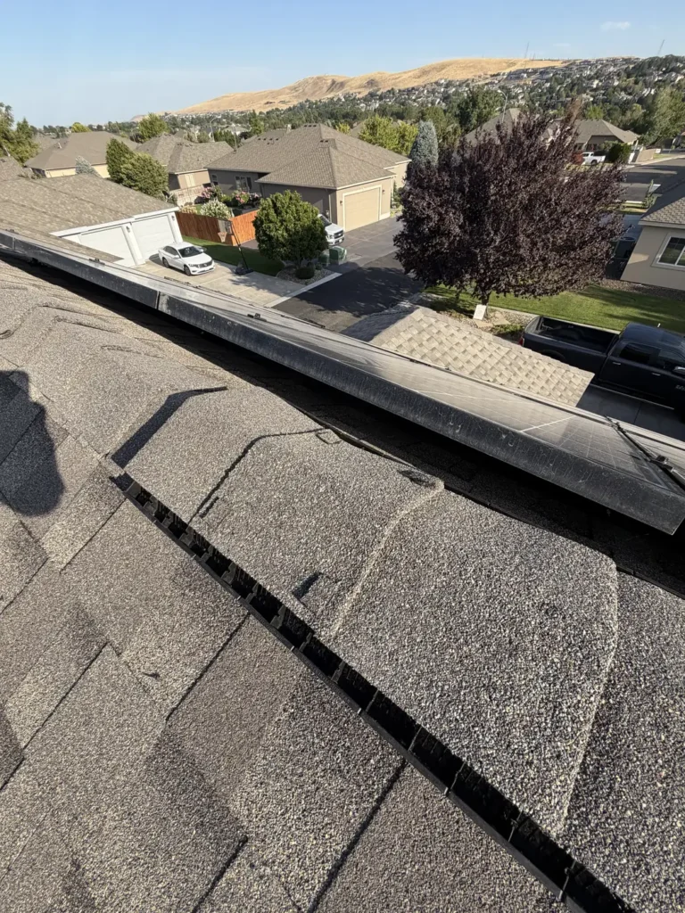 Looking down the edge of a finished roof to the street