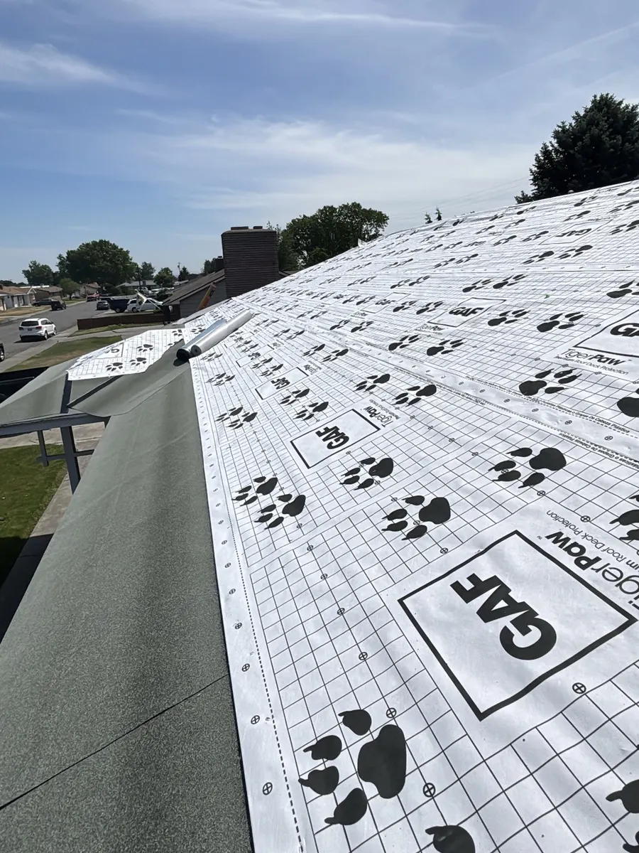 GAF underlayment going down on a roof deck partway through an installation