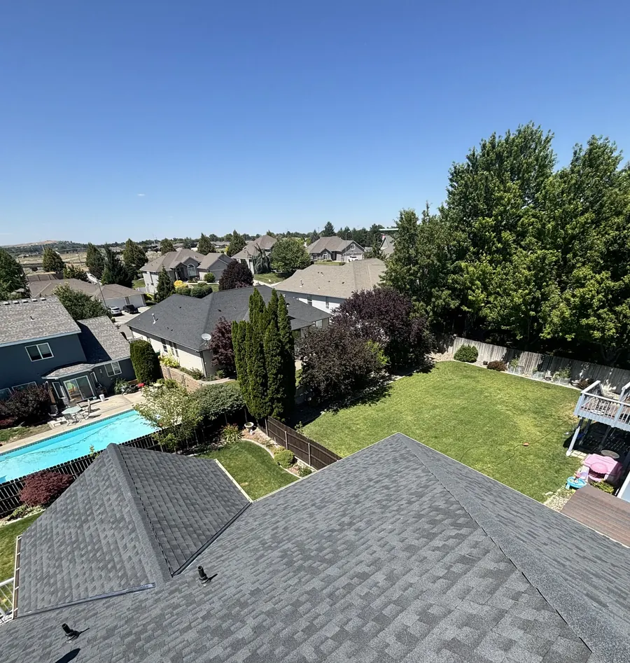 A Richland neighbourhood of back gardens and mature trees seen from a newly finished roof